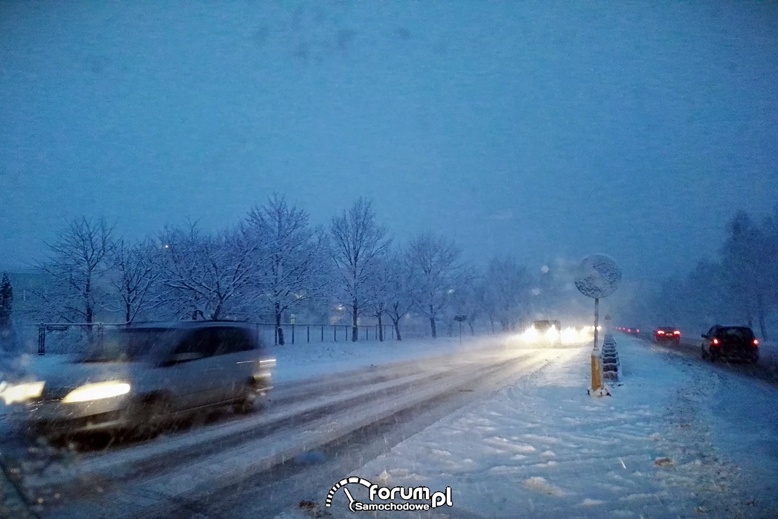 Padający śnieg, godziny wieczorne i utrudnienia na drogach